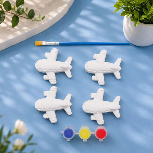 Aeroplane Set — 4 white Plaster of Paris planes with paint pots and brush on light blue background