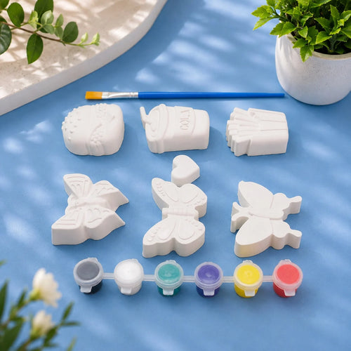 Butterfly & Dolls Mix Kit — 9 white Plaster of Paris figures with paint pots and brush on light blue background