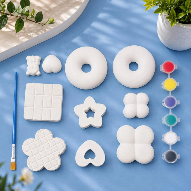 Donut, Bear & Shapes Kit — 9 white Plaster of Paris figures with paint pots and brush on light blue background