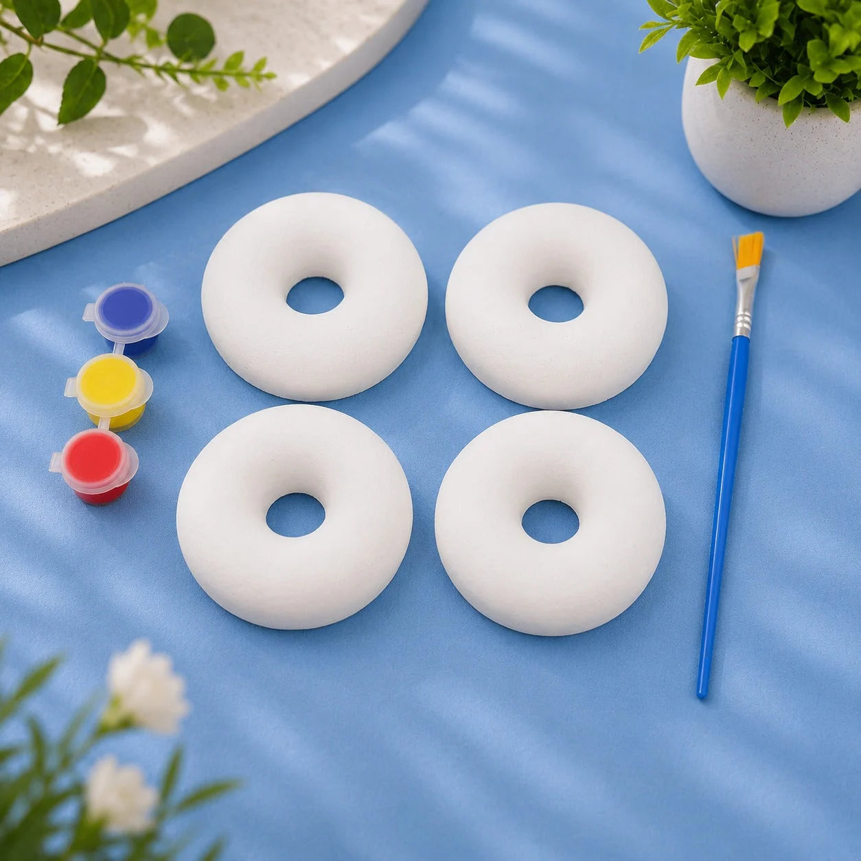 Donuts Set — 4 white Plaster of Paris donuts with paint pots and brush on light blue background