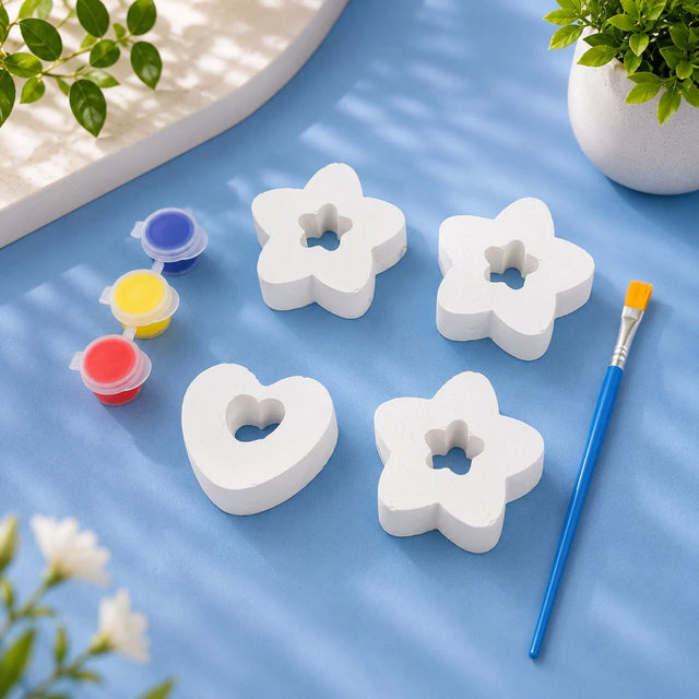 Stars, Hearts & Flowers Set — white Plaster of Paris figures with paint pots and brush on light blue background